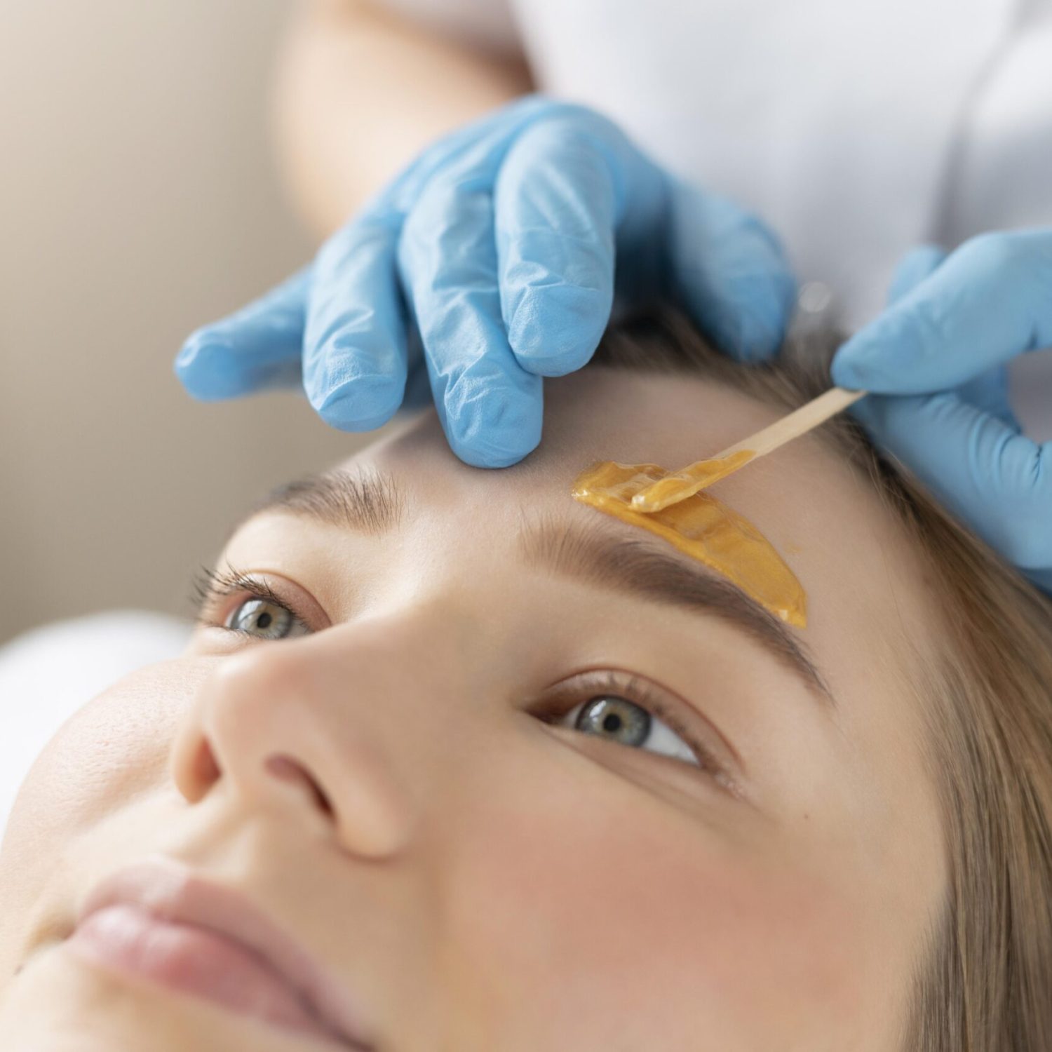 young-woman-getting-eyebrow-treatment-beauty-salon